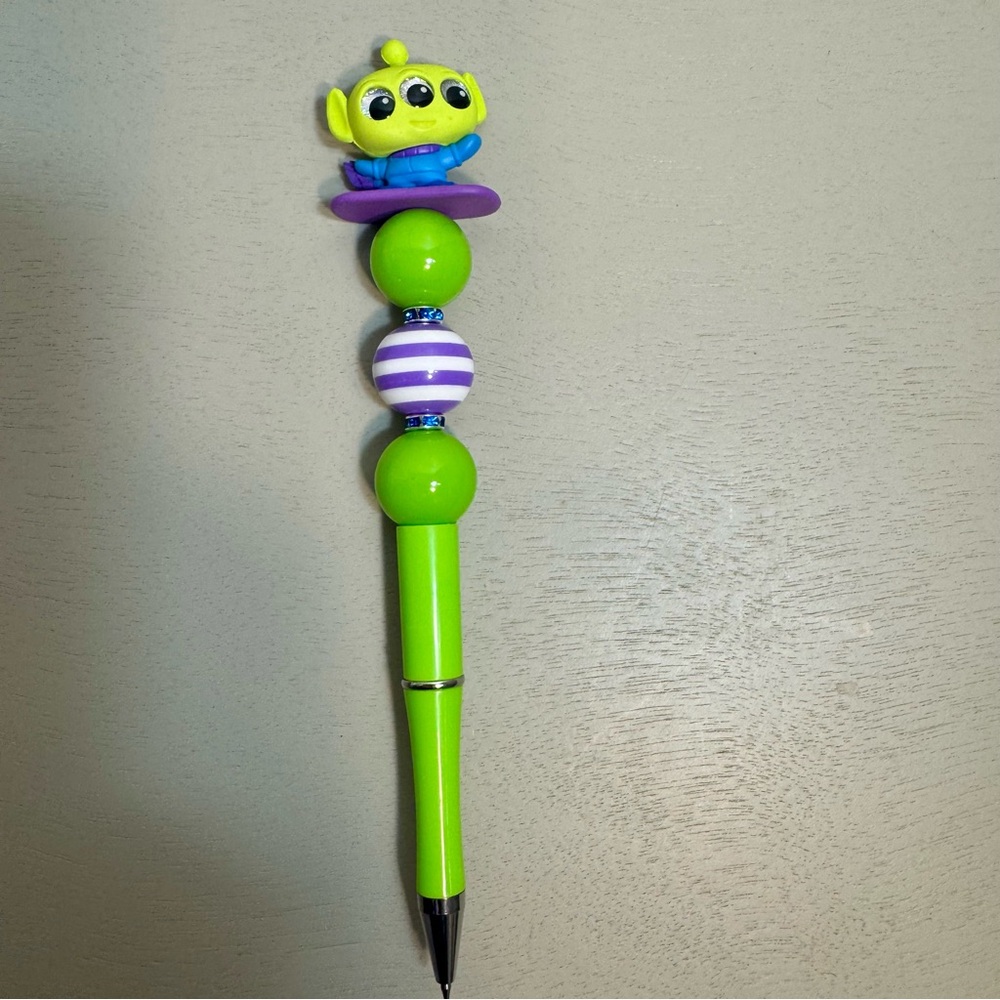 Handmade Disney themed beaded pen featuring a Toy Story alien figurine.